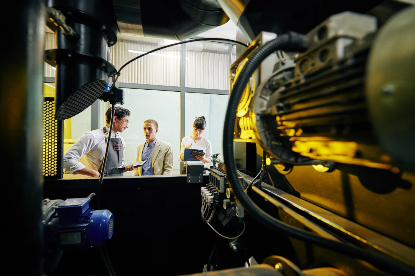 team-discussing-industrial-machinery